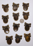 Closeout- 12pcs. of 30x22mm Antique Bronze Cameo Setting with Bow and Hole 862x