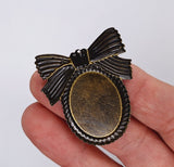 Closeout- 12pcs. of 30x22mm Antique Bronze Cameo Setting with Bow and Hole 862x